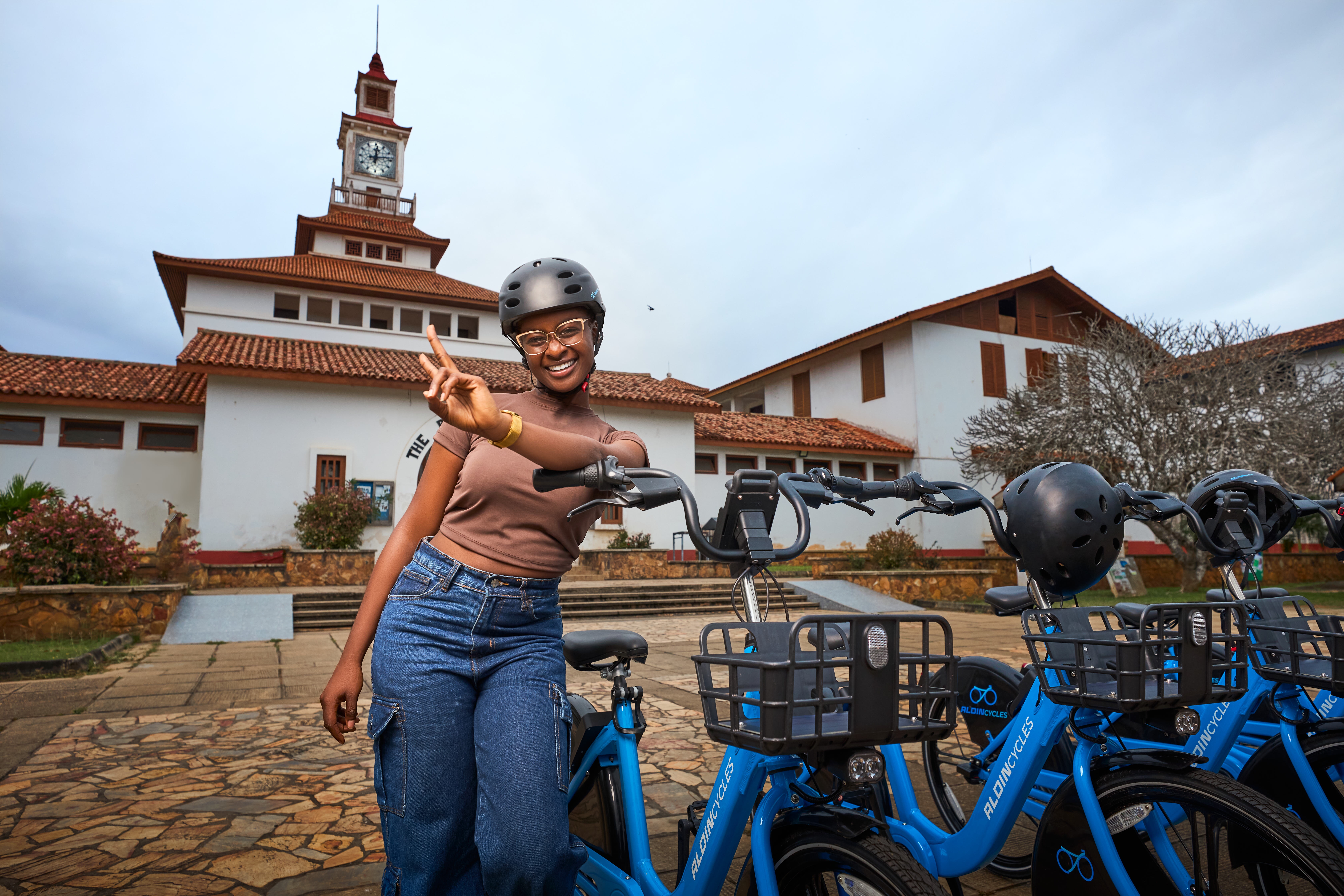 Model smiling and leaning on bike